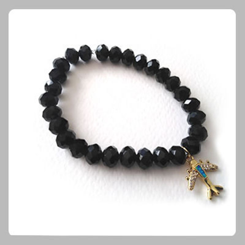 Pulsera en murano negro con dije de avión