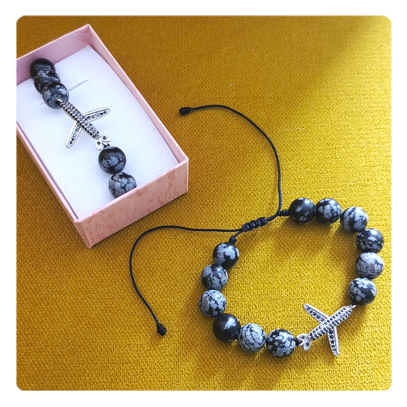 Pulsera con piedras de obsidiana con dije de avión en acero y rodio